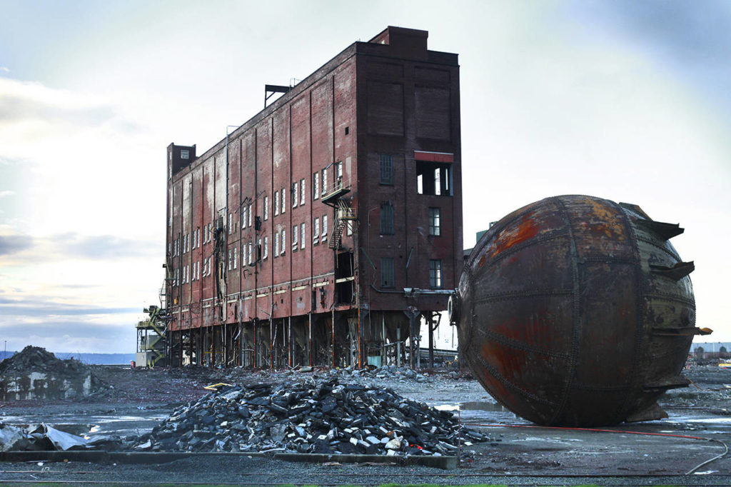 The digester building, built in the early 1930s, and a 32-foot acid accumulator is seen in November 2013, days before the building was scheduled to be demolished. (Genna Martin / Herald file)
