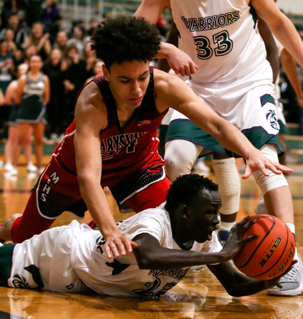 Edmonds-Woodway’s Mutdung Bol (bottom) battles Marysville Pilchuck’s Ethan Jackson for a loose ball during a Wesco 3A game Friday in Edmonds. Jackson and the Tomahawks won 55-53. (Kevin Clark / The Herald)
