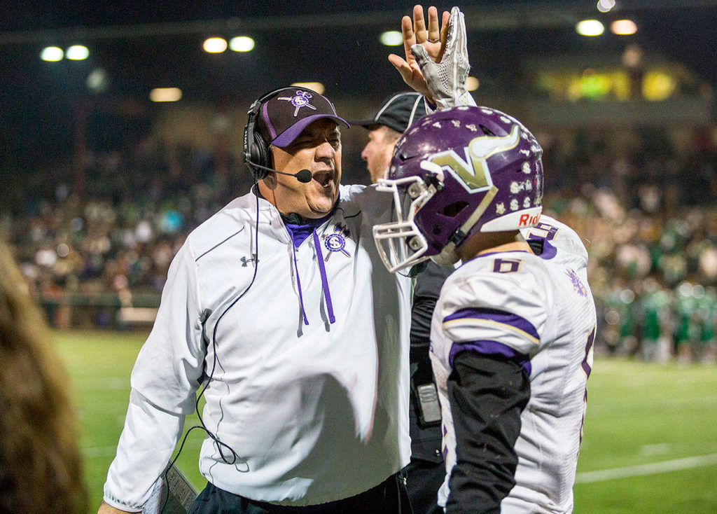 Lake Stevens head coach Tom Tri high fives Dallas Landeros on Nov. 24, during the Class 4A state state semifinal game against Woodinville at Pop Keeney Stadium in Bothell. (Olivia Vanni / The Herald)
