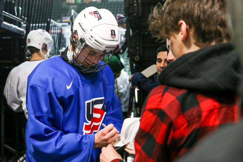 Jack Hughes of USA Hockey’s National Junior Team signs an autograph before practice Saturday morning at the Angel of the Winds Arena in Everett. (Kevin Clark / The Herald)
