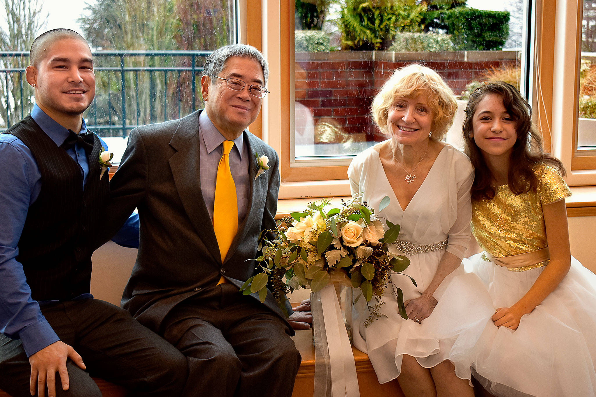 Just married at the Everett Public Library and sitting together for a family photograph are Ed and Gaylen Wada (center), Ed’s adult son, Ben Wada (left) and Gaylen’s granddaughter, Belle Rose, 13. (Contributed photo)