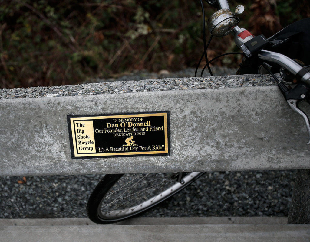 The last words of “The Big Shots Bicycle Group” founder Dan O’Donnell are inscribed on a plaque on a bench along the Centennial Trail in Arlington. (Andy Bronson / The Herald)
