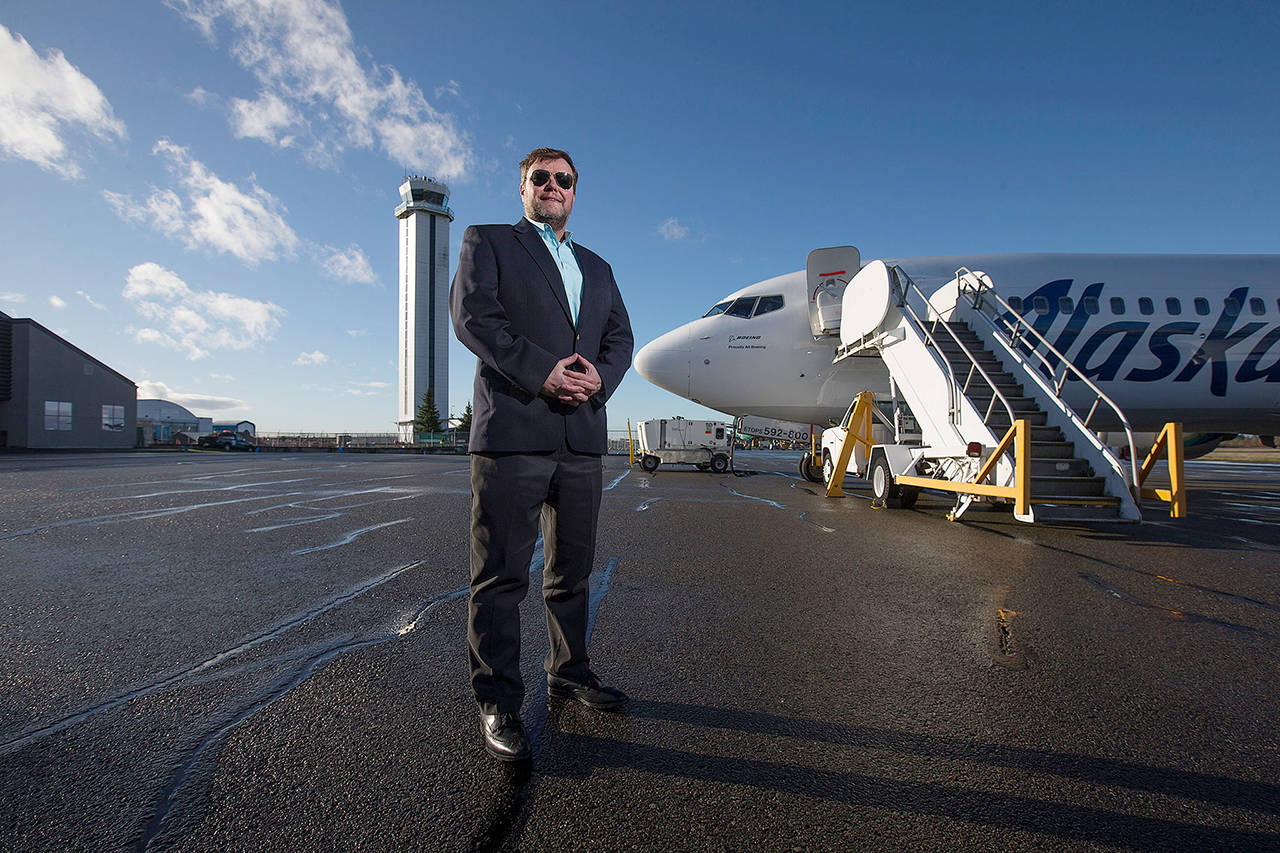 “They are some of the most popular (routes) for the Everett community, specifically,” said John Kirby, Alaska’s vice president of capacity planning, seen here in front of a 737-800 and the Paine Field Tower on Jan. 16 in Everett. (Andy Bronson / Herald file)
