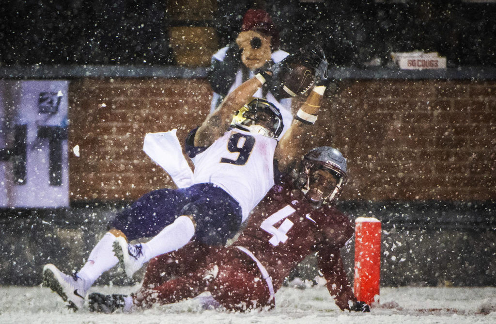 Washington running back Myles Gaskin (9) dives into the end zone as he’s tackled by Washington State’s Marcus Strong during the third quarter of an NCAA college football game Nov. 23 in Pullman. (Joshua Bessex / The News Tribune file)
