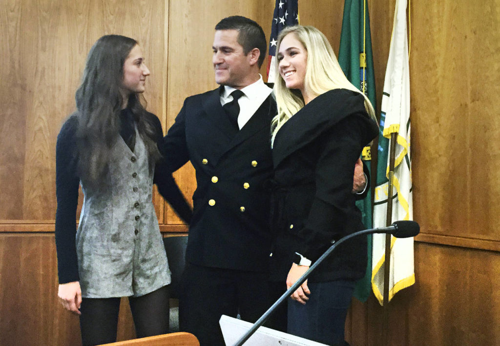 Kraski’s daughters Olivia (left) and Jordan joined their dad at a ceremony in the City Council Chambers. (Arlington Times)
