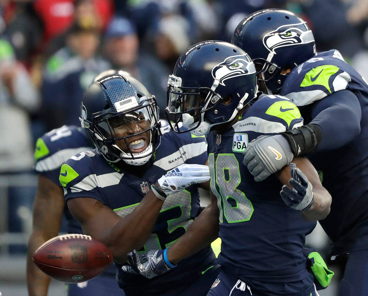 Seahawks wide receiver Jaron Brown (center) celebrates with wide receiver David Moore (left) and offensive tackle Duane Brown (right) after catching a touchdown during the second half of a game against the 49ers on Dec. 2, 2018, in Seattle. (AP Photo/Elaine Thompson)