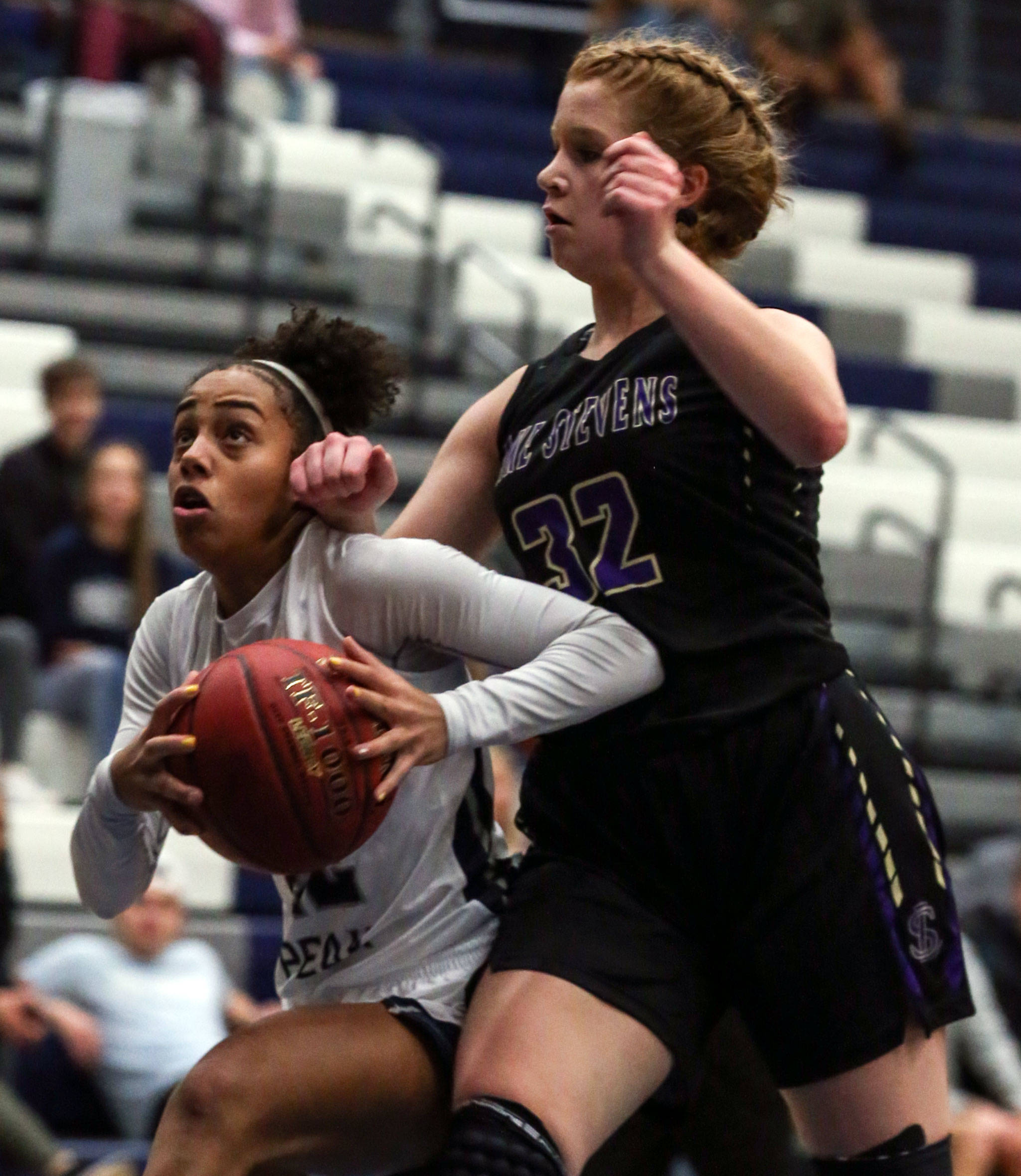 Glacier Peak’s Aaliyah Collins attempts a shot with Lake Stevens’ Cori Wilcox trailing Tuesday night at Glacier Peak High School in Snohomish on December 18, 2019. Glacier Peak won 68-50. (Kevin Clark / The Herald)