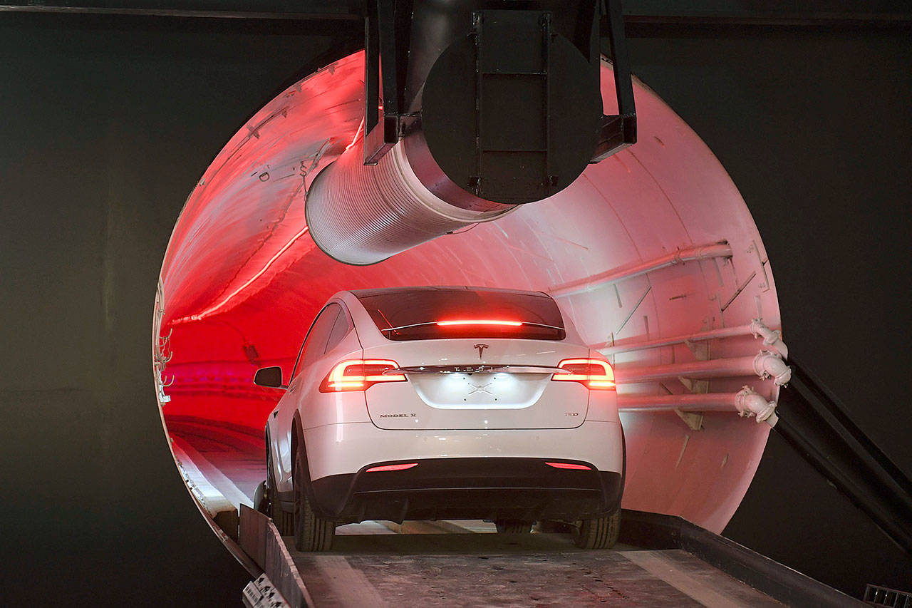 A modified Tesla Model X drives in the tunnel entrance before an unveiling event for the Boring Co. test tunnel in Hawthorne, California, on Tuesday. (Robyn Beck/Pool Photo via AP)