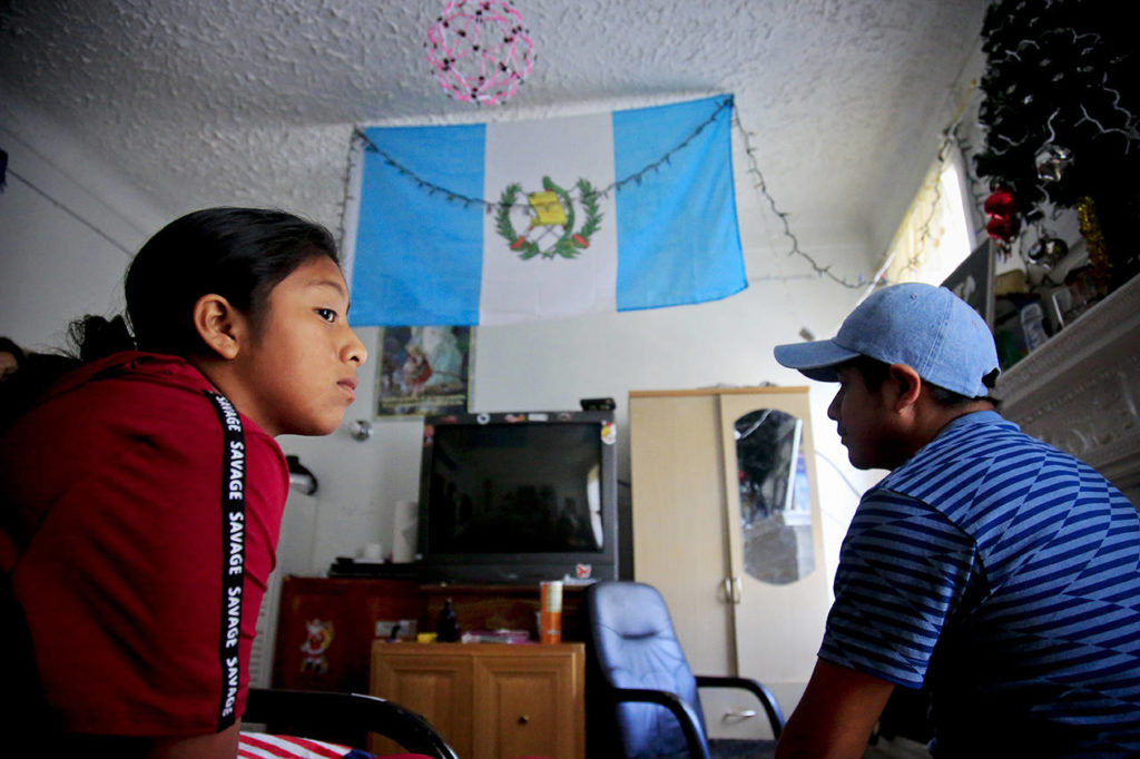 Manuela Marcelino, 11 (left) sits with her father, Manuel Marcelino Tzah, from Guatemala, inside their apartment hours after her release from immigrant detention, on July 18 in the Brooklyn borough of New York. Manuela was taken from him and held in a Southwest Keys facility in Houston for nearly two months. He said his family is still trying to process the pain of separation and detention. “She’s doing ok now, she is going to school,” said Marcelino, whose immigration case is pending in a New York court near his new home in Brooklyn. (AP Photo/Bebeto Matthews, file)

