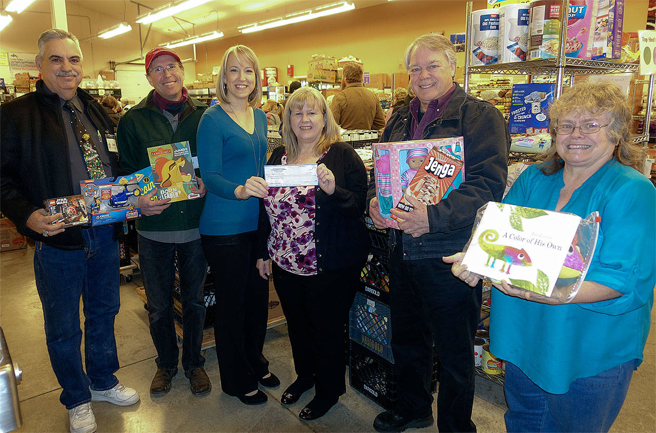 Greater Marysville Tulalip Chamber of Commerce President Jesica Stickles presents a donation check to Marysville Community Food Bank board members. (Contributed photo)