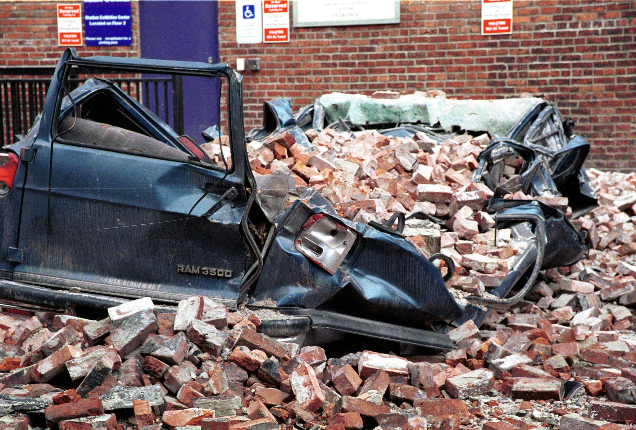 As seen on March 4, 2001, a large van was crushed by earthquake debris in a Seattle parking lot. (Kevin Galvin/FEMA)
