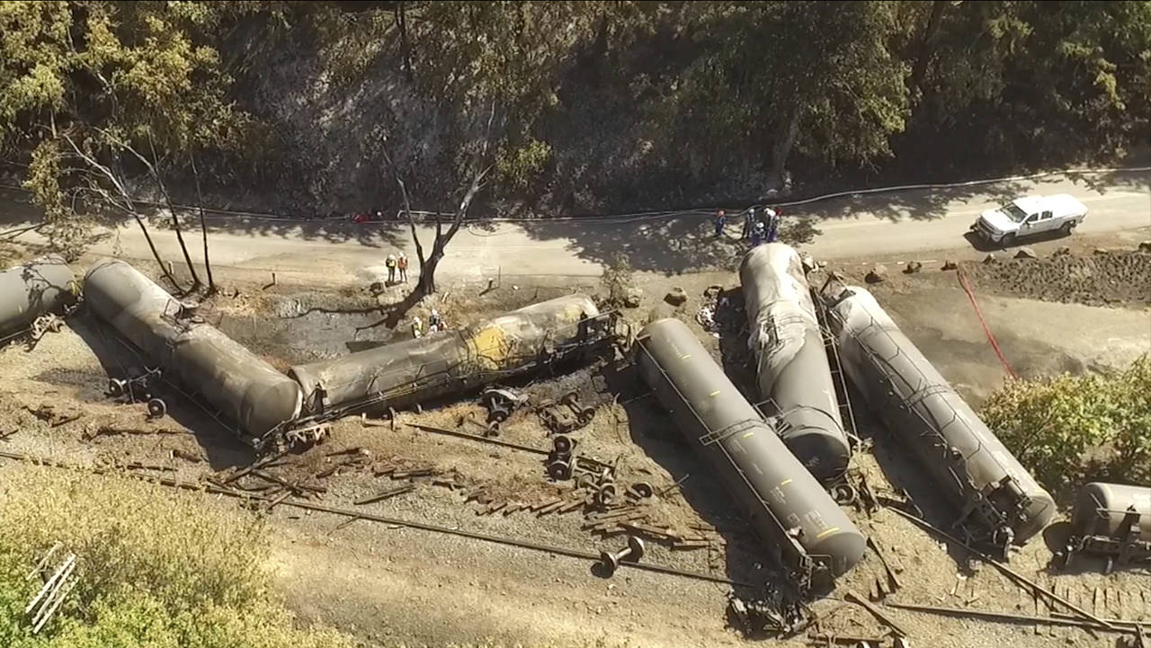 In this 2016 aerial video image taken from a drone, crumpled oil tankers lie beside the railroad tracks after a fiery train derailment that prompted evacuations from the tiny Columbia River Gorge town of Mosier, Oregon. (Brent Foster via AP, file)