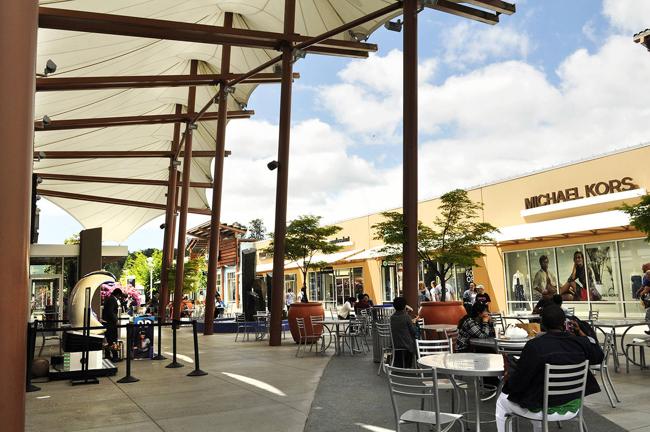 People shop at Quil Ceda Village’s Seattle Premium Outlets mall. (Sue Misao / Herald file)