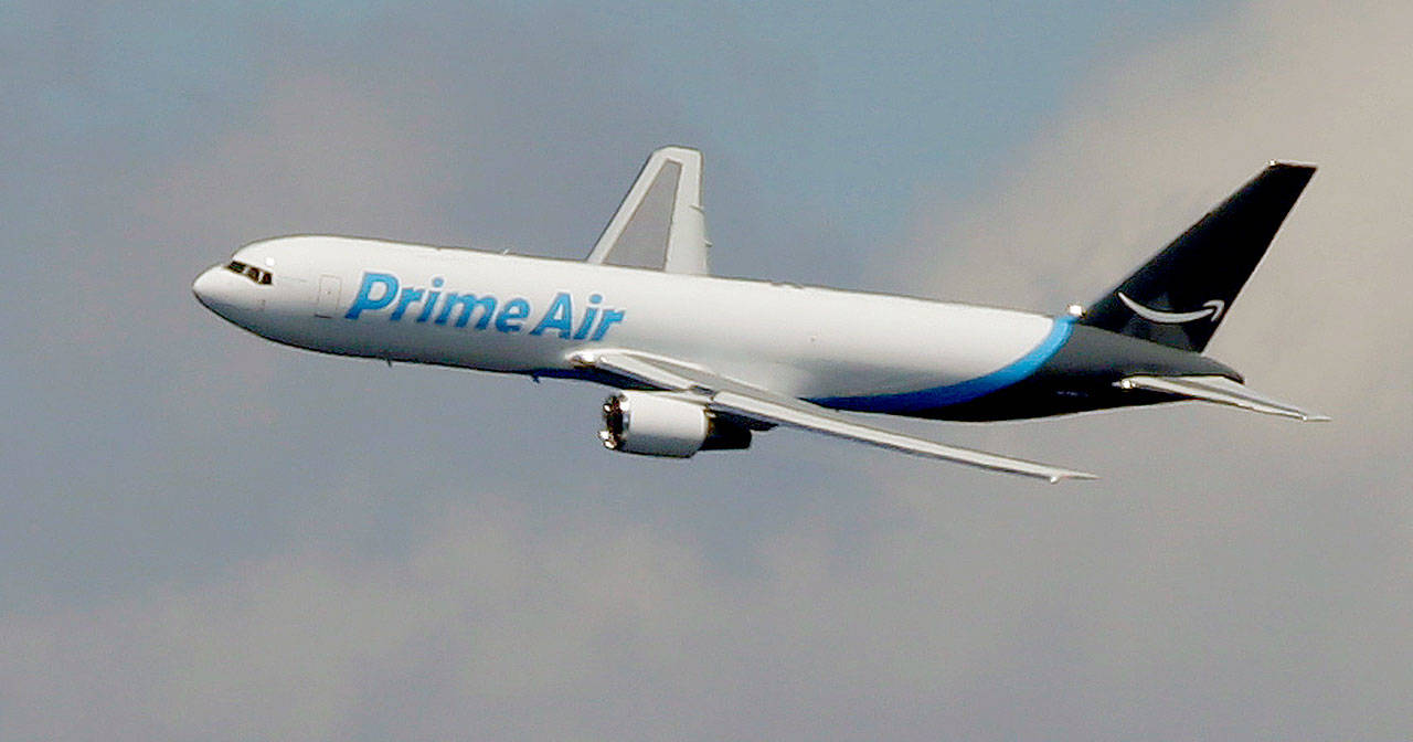 A Boeing 767 with Amazon “Prime Air” livery flies over Lake Washington in 2016. (AP Photo/Ted S. Warren, File)