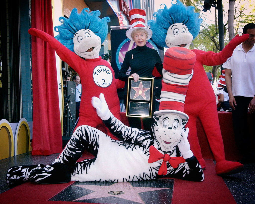 Audrey Geisel, widow of famed children’s book author Theodor Seuss Geisel, better known as Dr. Seuss, poses with The Cat in the Hat and Thing 1 and Thing 2, who are characters from his books, at the dedication of Dr. Seuss’ posthumous star on the Hollywood Walk of Fame in Los Angeles in 2004. (Reed Saxon / Associated Press file)
