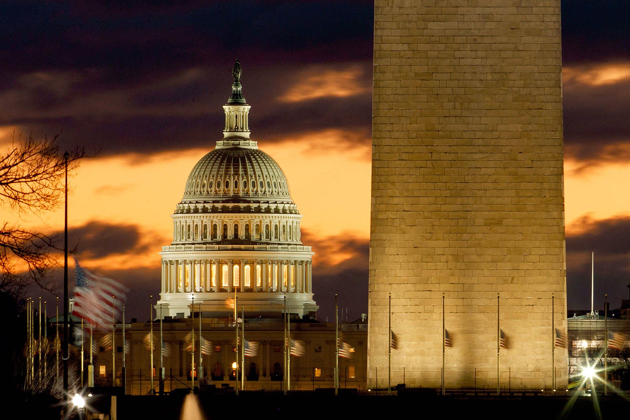 The U.S. Capitol dome and the base of the Washington Monument just before sunrise in Washington on Saturday. (AP Photo/Carolyn Kaster)