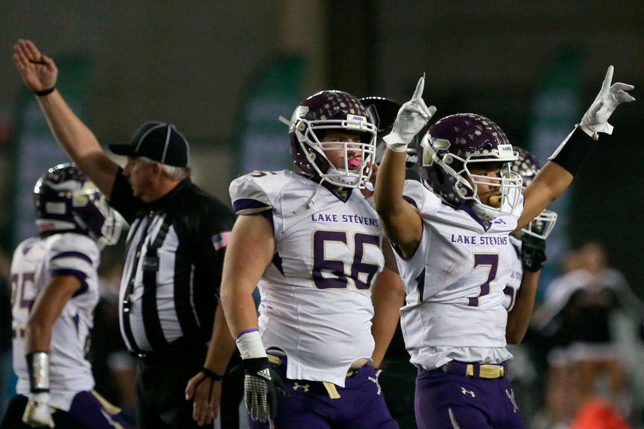 Lake Stevens’ Isaiah Harris (right) celebrates a fumble recovery in the first quarter of the 4A state championship game against Union on Dec. 1, 2018, in Tacoma. (Kevin Clark / The Herald)