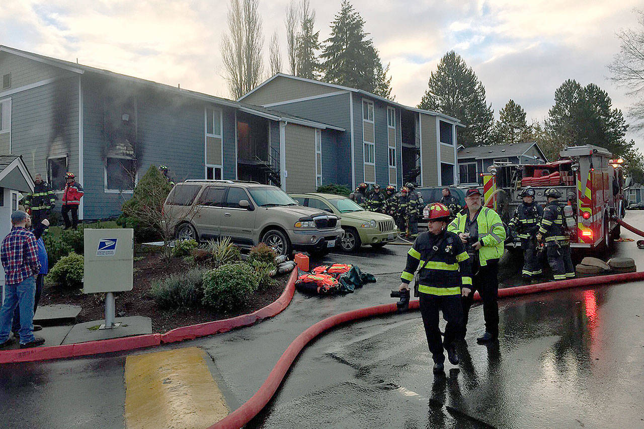 Firefighters inspect the scene of an apartment fire Monday in Everett. (Everett Fire Department)