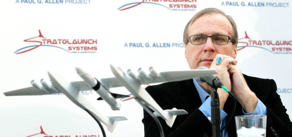 Microsoft co-founder Paul Allen looks across at a model of a giant airplane and spaceship he planned to build, Dec. 13, 2011, in Seattle. (AP Photo/Elaine Thompson, file)
