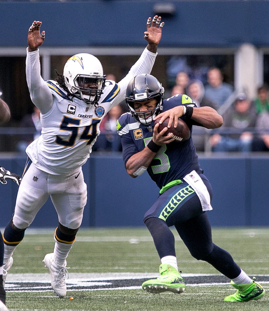 Seahawks quarterback Russell Wilson is sacked by Chargers defensive lineman Melvin Ingram III at CenturyLink Field in Seattle on Nov. 4. Chargers won 25-17. (Kevin Clark / The Herald)
