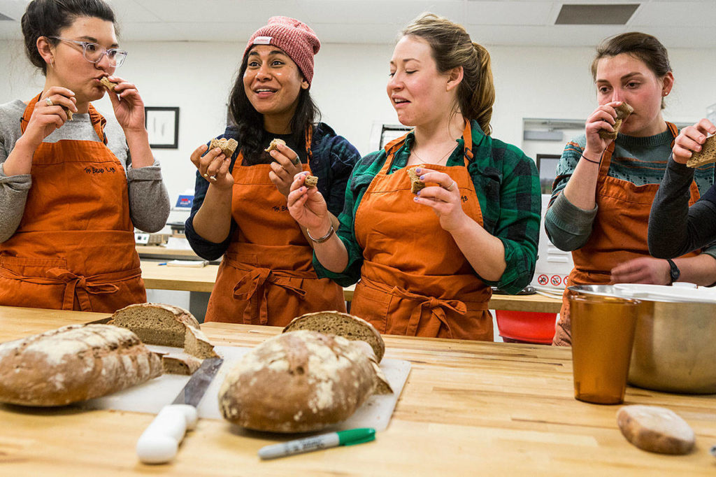 Graduate students from Tufts University, Tetyana Pecherska, Nayla Bezares, Claire Loudis and Test Baker Julia Bernstein, right, smell, feel and taste salted and unsalted breads at The Bread Lab in Burlington. (Andy Bronson / The Herald)
