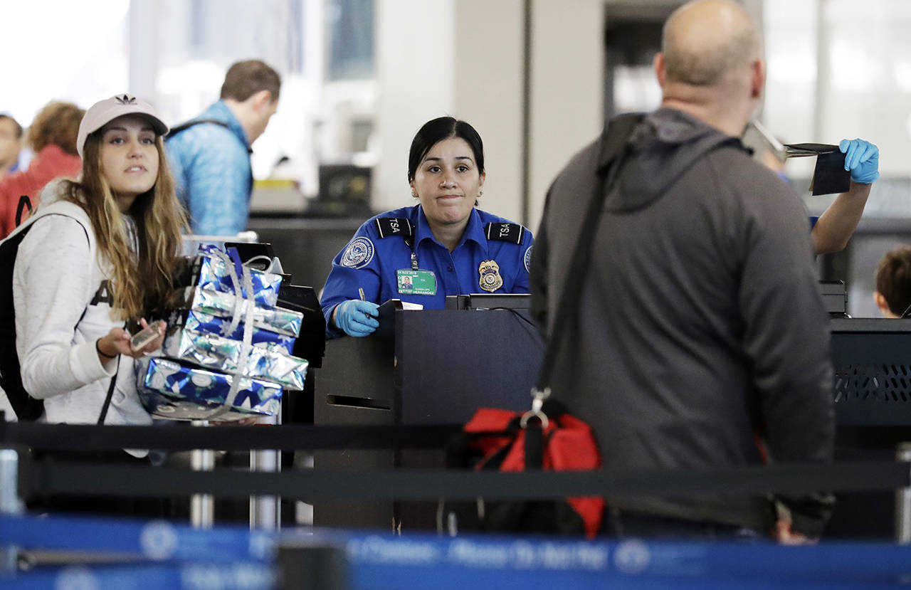 A TSA worker works at O’Hare International Airport in Chicago on Tuesday, Dec. 25, 2018. (AP Photo/Nam Y. Huh)