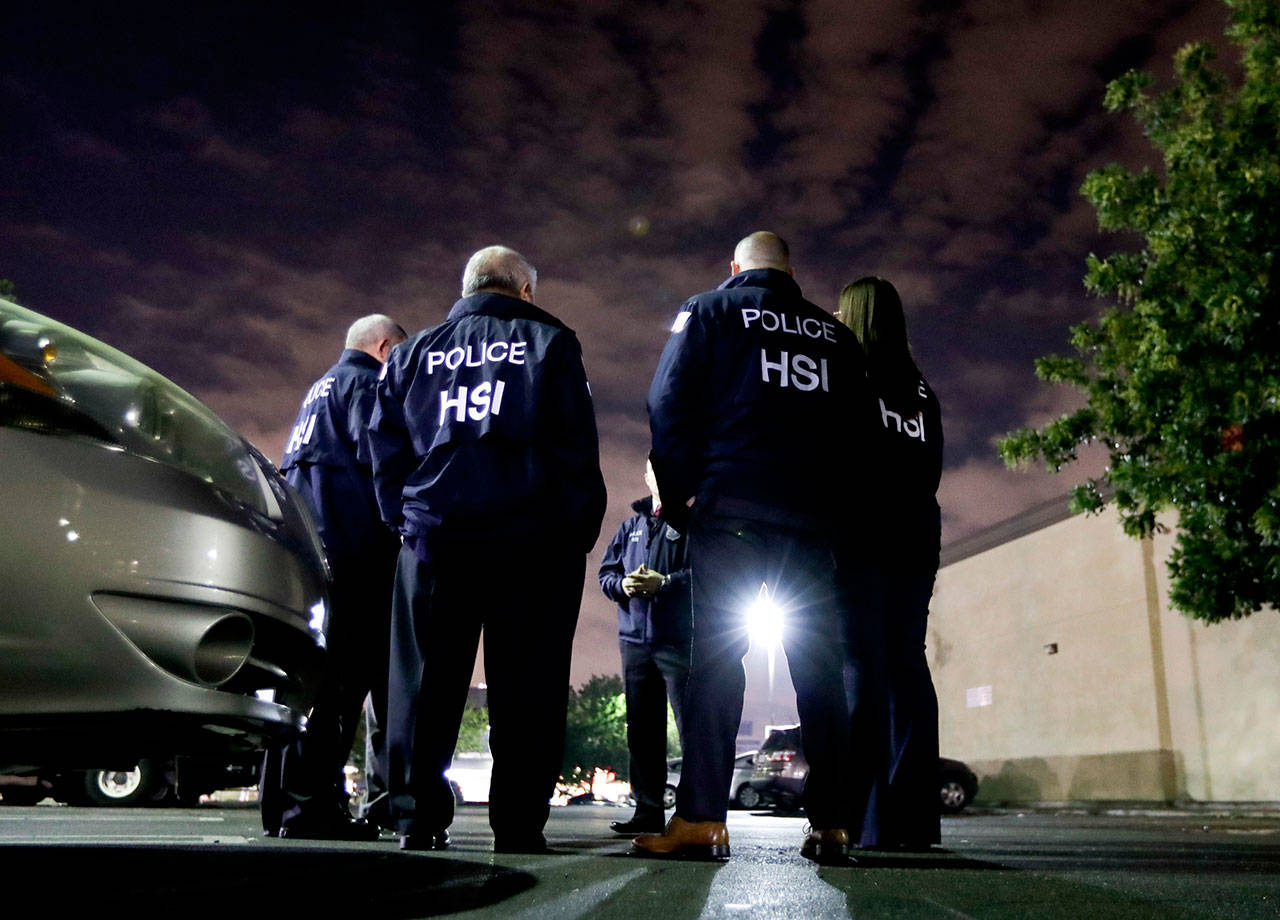 U.S. Immigration and Customs Enforcement agents gather before serving an employment audit notice Jan. 10, 2018, at a 7-Eleven convenience store, in Los Angeles. U.S. Immigration and Customs Enforcement is the face of President Donald Trump’s hard-line immigration policy. But agency officials say their mandate is misunderstood. (AP Photo/Chris Carlson, File)