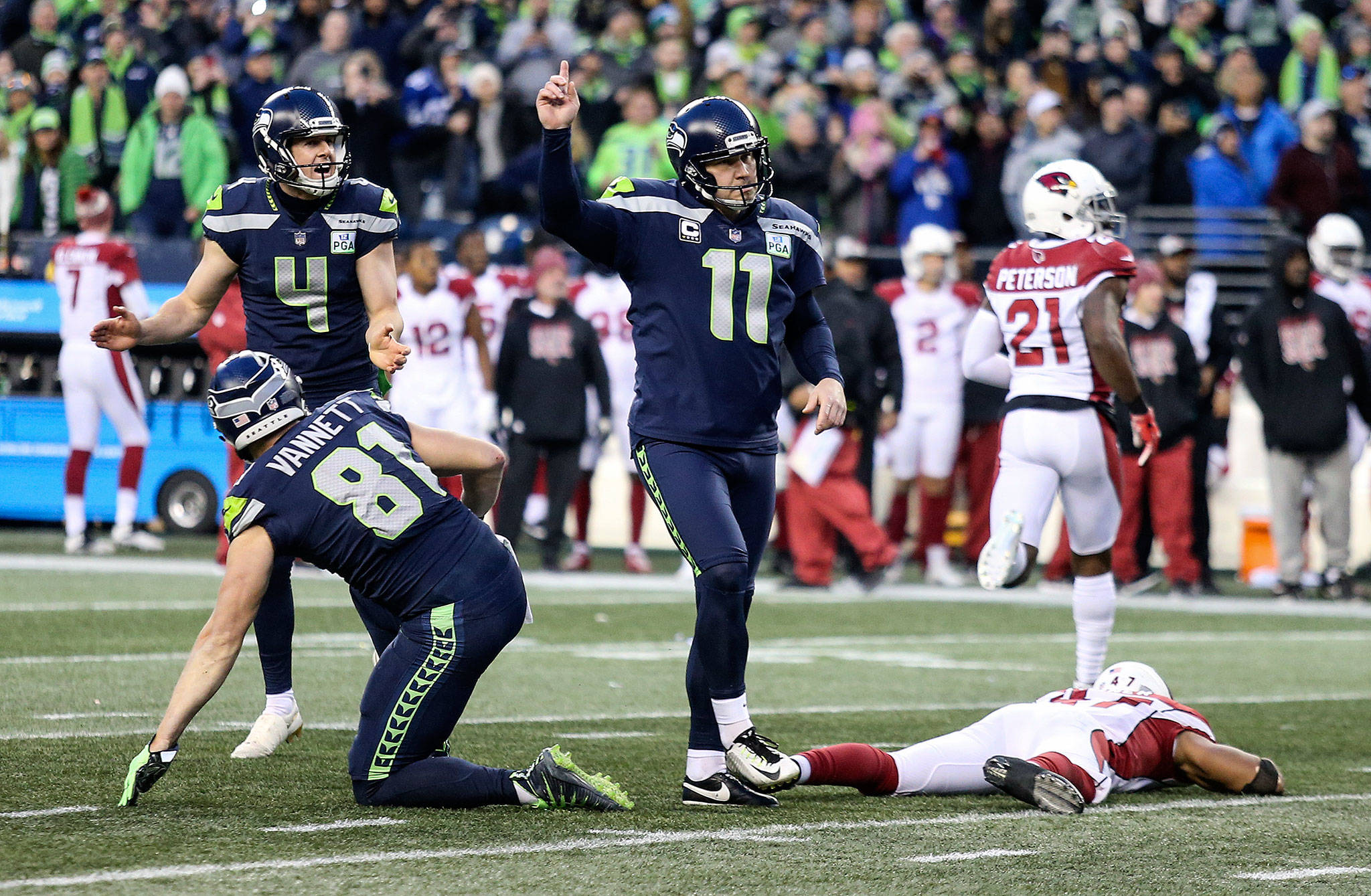 Seattle’s Sebastian Janikowski (11) and teammates celebrate his game-winning field goal that sealed the Seahawks’ 27-24 win over Arizona on Sunday at CenturyLink Field in Seattle. (Andy Bronson / The Herald)