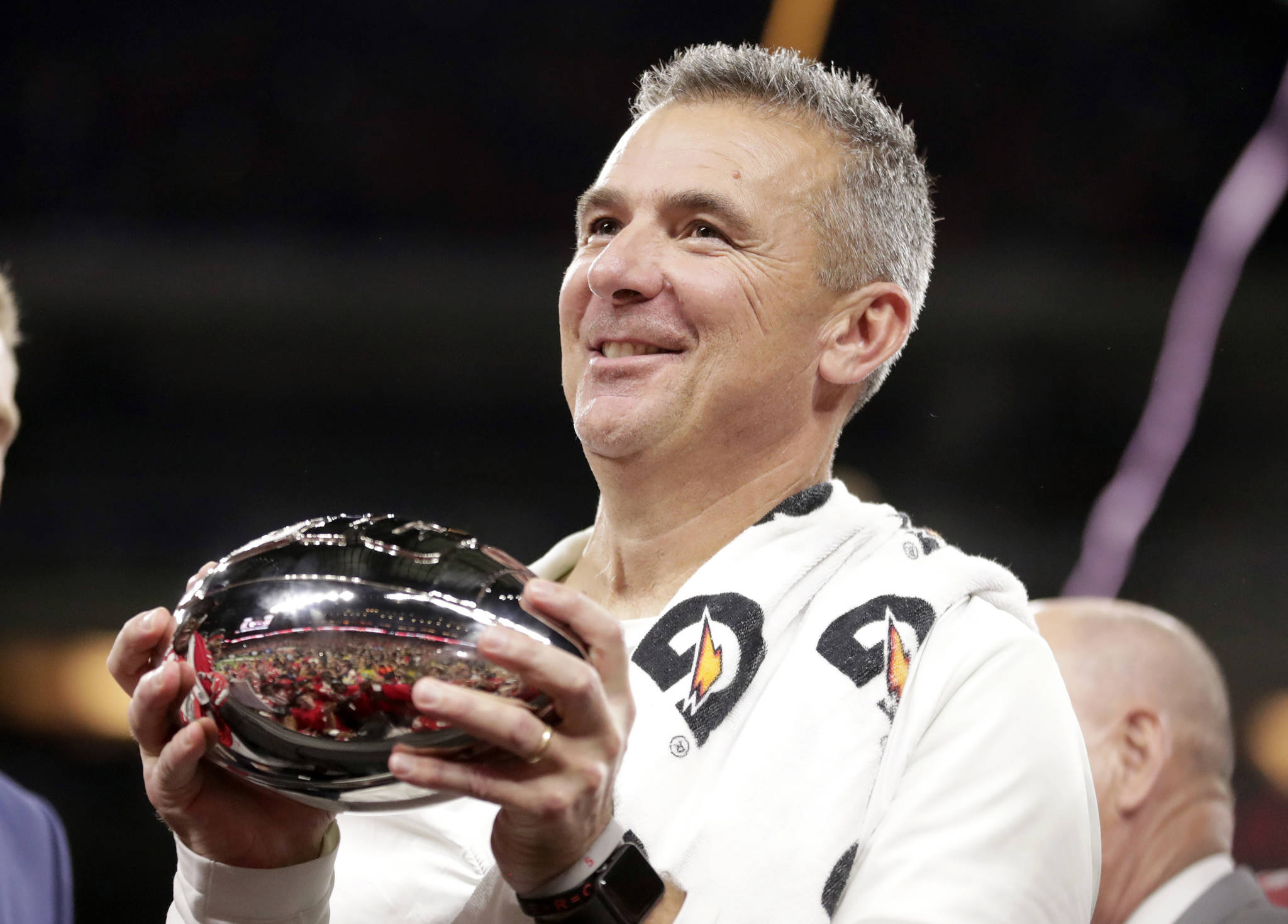 Michael Conroy / Associated Press                                Ohio State football coach Urban Meyer holds the trophy after Ohio State defeated Northwestern in the Big Ten championship game Dec. 2, 2018.