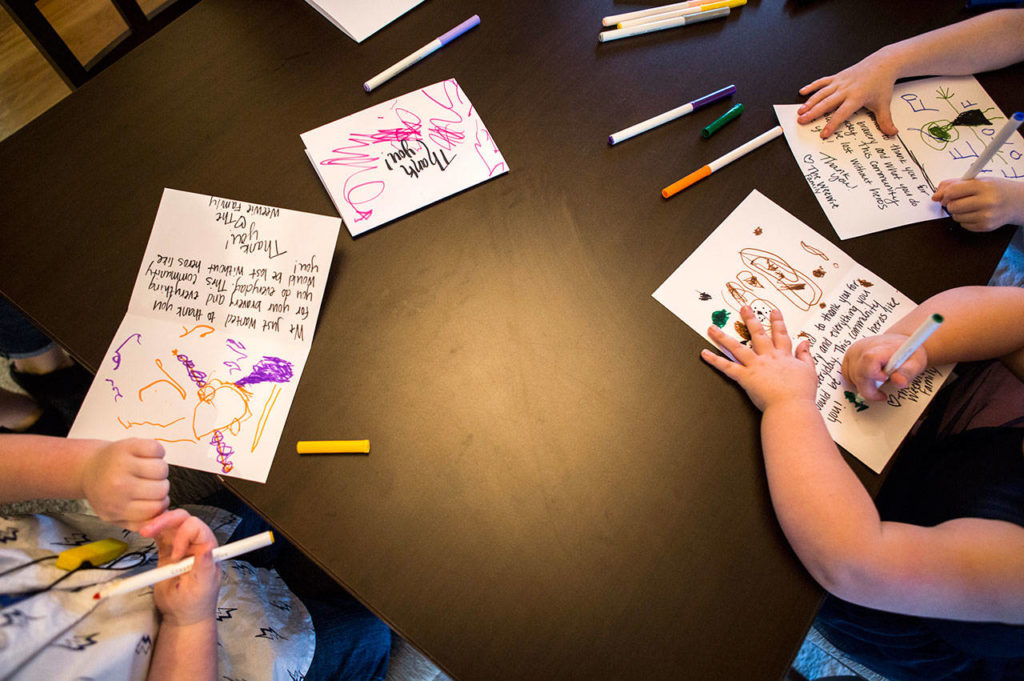 Kids draw on thank-you cards on for firefighters. (Olivia Vanni / The Herald)
