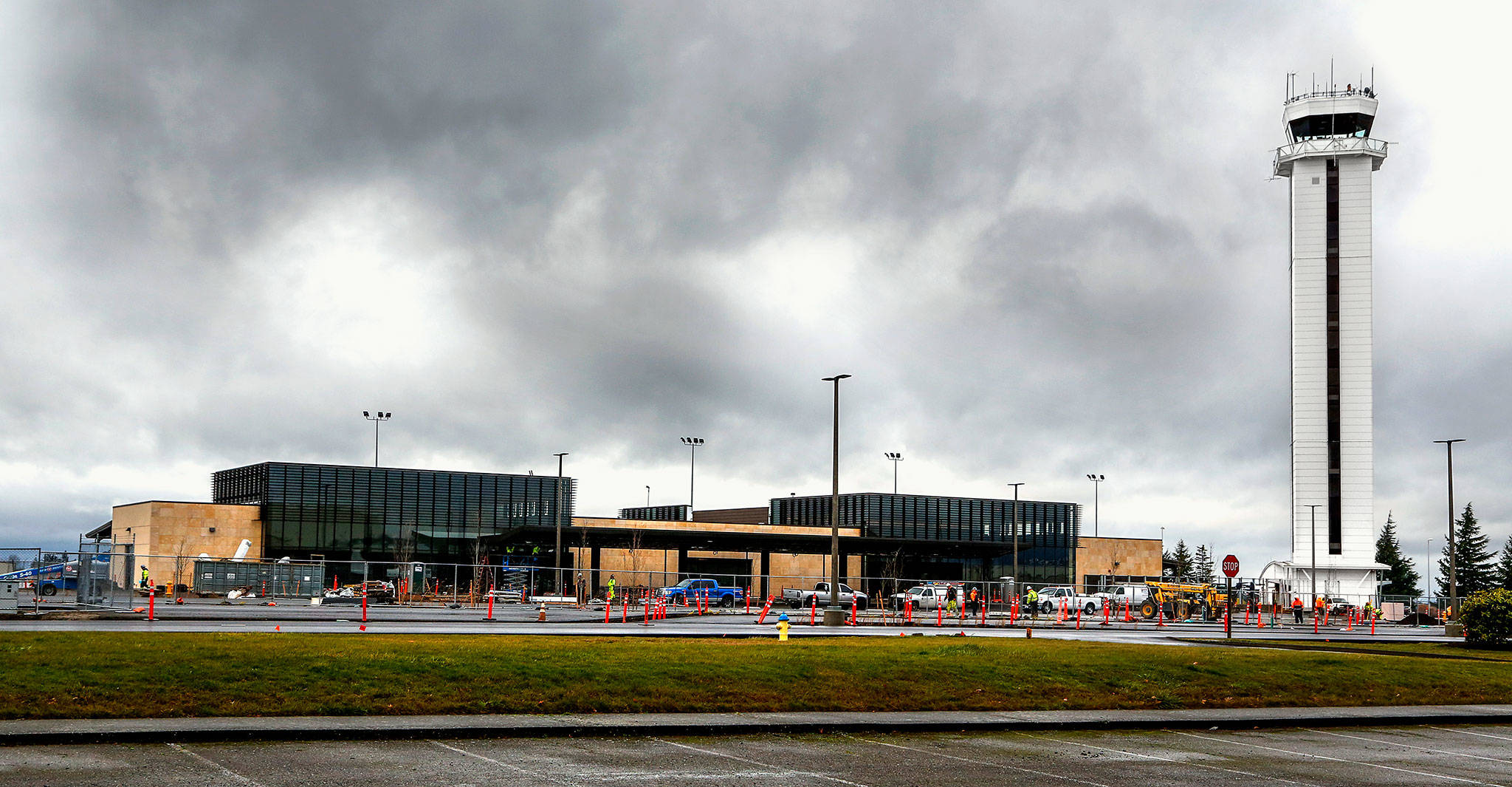 Workers continue to put finishing touches on the new Paine Field passenger terminal at the Snohomish County Airport Thursday. Commercial flights will start next month from the terminal, which is owned by Propeller Airports. (Dan Bates / The Herald)