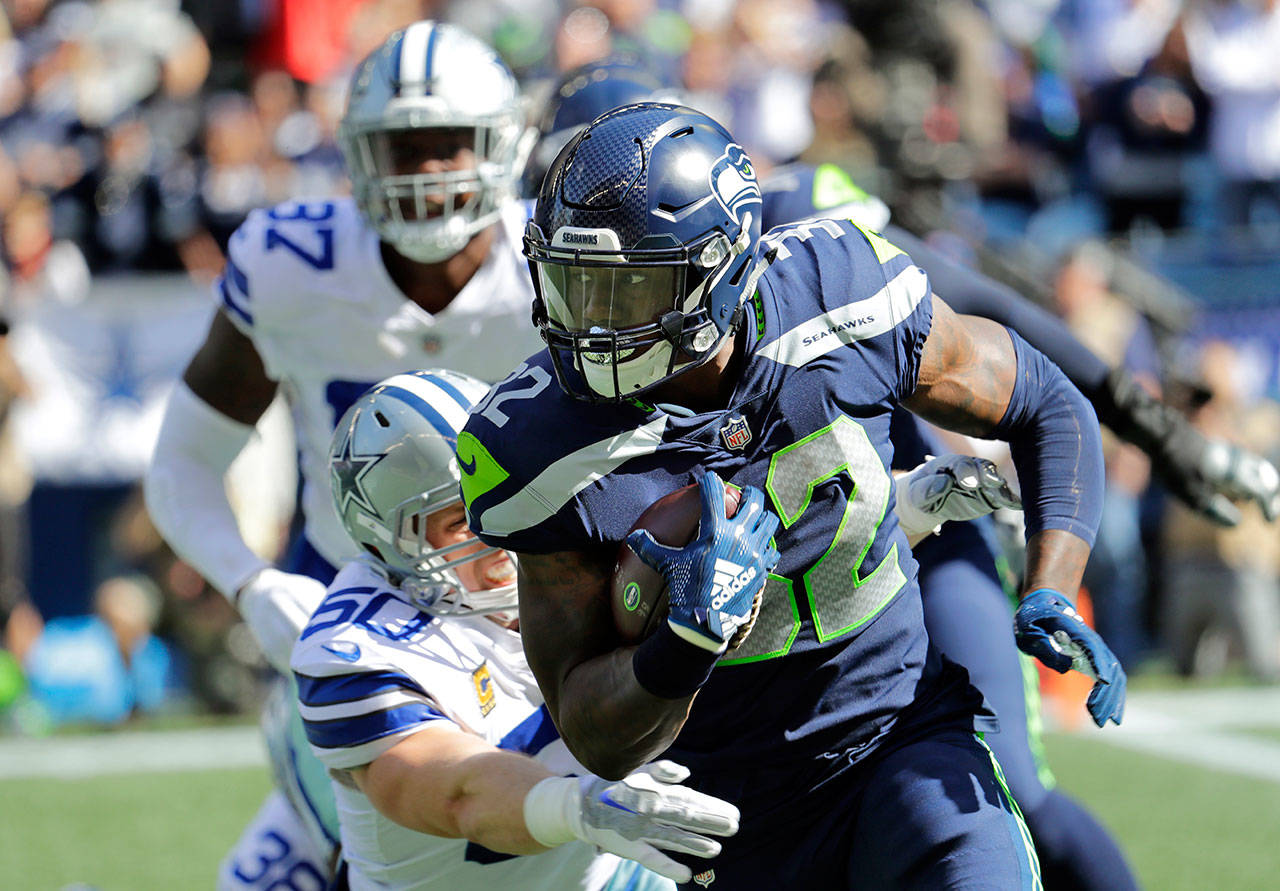 Seahawks running back Chris Carson carries the ball against the Cowboys during the first half of a game on Sept. 23, 2018, in Seattle. (AP Photo/Elaine Thompson)
