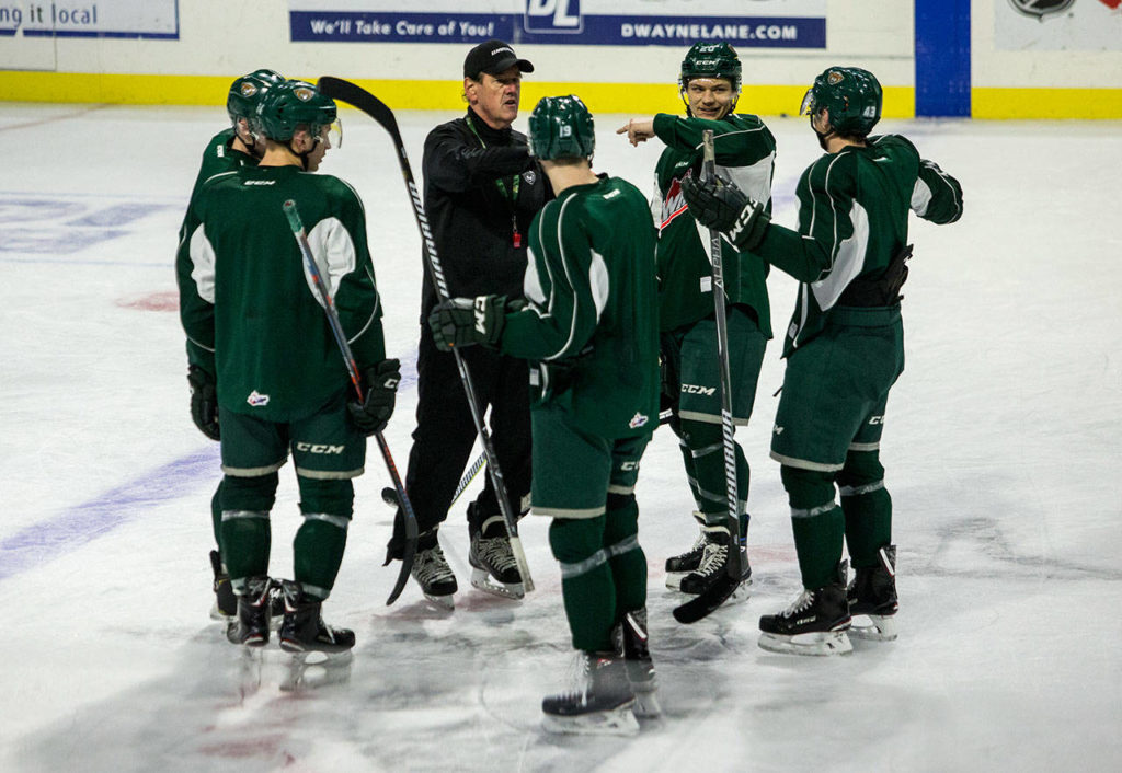 Zach Andrusiak listens as assistant coach Harry Mahood talks during Silvertips practice Wednesday in Everett. (Olivia Vanni / The Herald)
