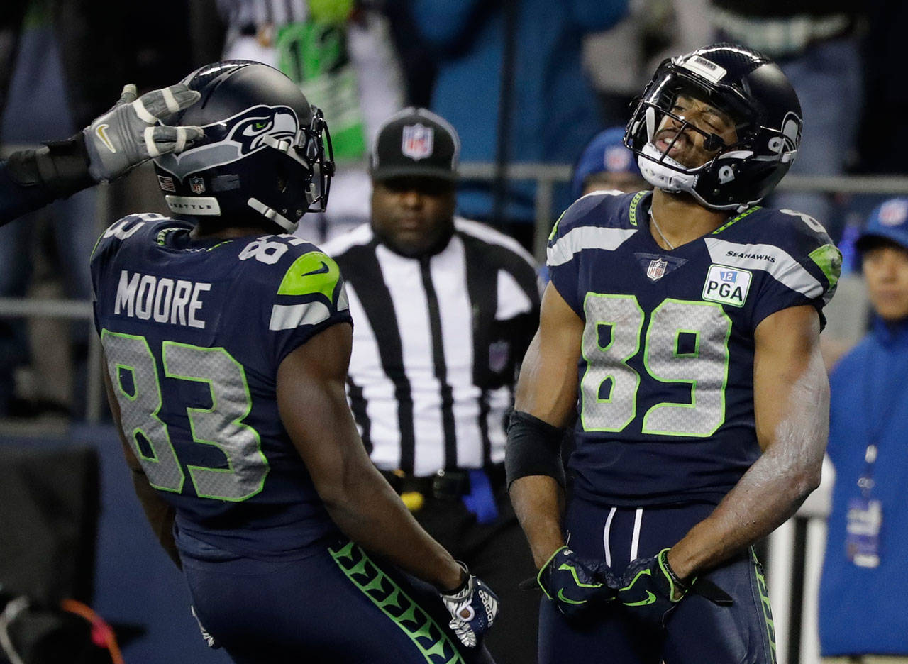 Seahawks wide receiver Doug Baldwin (89) celebrates with wide receiver David Moore after Baldwin scored a touchdown against the Chiefs during the second half of a game on Dec. 23, 2018, in Seattle. (AP Photo/Elaine Thompson)