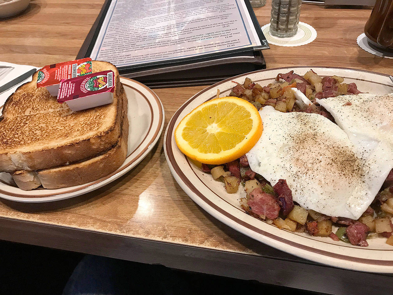 The Totem hash — homemade corned beef, potatoes and onions, topped with fried eggs — at Totem Family Diner in Everett. (Mark Carlson / The Herald)