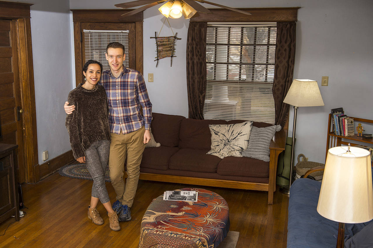 In this Dec. 13, 2018 photo, Katharen and Scott Wiese pose in the living room of their apartment near 13th and D streets in Lincoln, Nebraska. Wiese knows she is one of the lucky renters. Her apartment is affordable — about $600 a month. (Kayla Wolf/Lincoln Journal Star via AP)