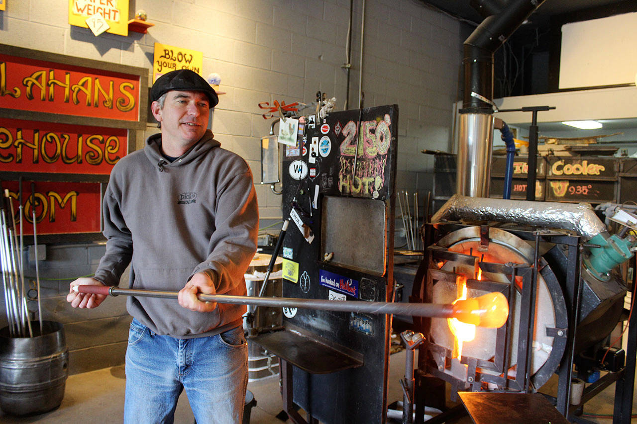 Callahan McVay makes a sea float in his Firehouse Studio and Gallery. (Patricia Guthrie / Whidbey News Group)