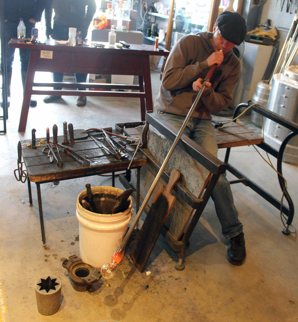 Callahan McVay makes a sea float in his Firehouse Studio and Gallery. He’s made thousands of small glass orbs over the years for the annual Langley Sea Float Scramble. (Patricia Guthrie / Whidbey News Group)
