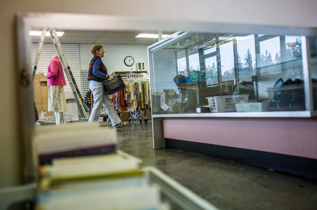 Volunteers help move and unpack boxes at the Edmonds Senior Center’s new thrift store. (Olivia Vanni / The Herald)
