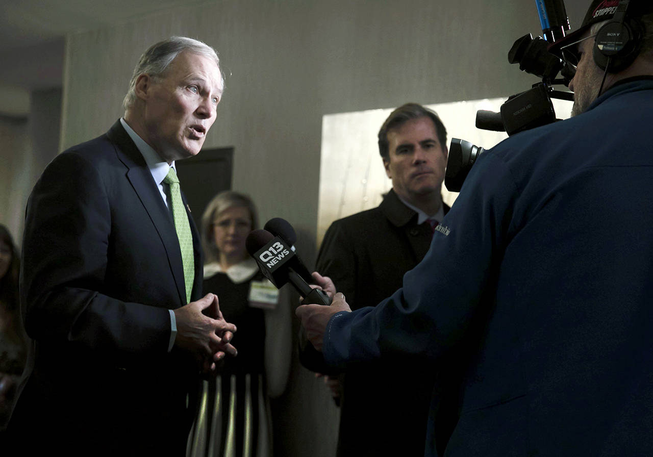 Washington Gov. Jay Inslee speaks with the media at the annual Washington Cannabis Summit on Friday in SeaTac. Inslee says he plans to pardon thousands of convictions for misdemeanor pot possession. (Erika Schultz / The Seattle Times via AP)