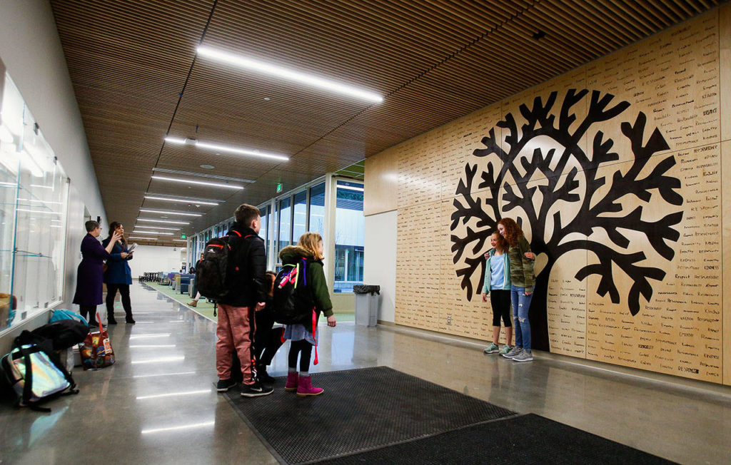 As students begin to arrive Monday at the new Madrona K-8 School in Edmonds, one thing is clear. The madrona tree is a big hit with the heart in the center and all the hand written words that students and staff chose to represent their most desired attributes. (Dan Bates / Herald Staff Photographer
