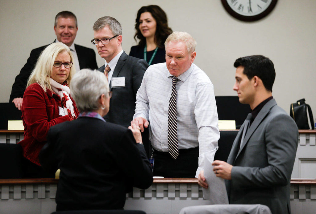 Rep. Carolyn Eslick, R-Sultan, (front) chats with incoming House freshmen from Snohomish County (from left), Democrat Dave Paul, of Oak Harbor, Republican Robert Sutherland, of Granite Falls, and Democrat Jared Mead, of Mill Creek, before an orientation session at the Capitol. The three men will be sworn into office Monday, at the start of the 2019 legislative session. (Andy Bronson / The Herald)
