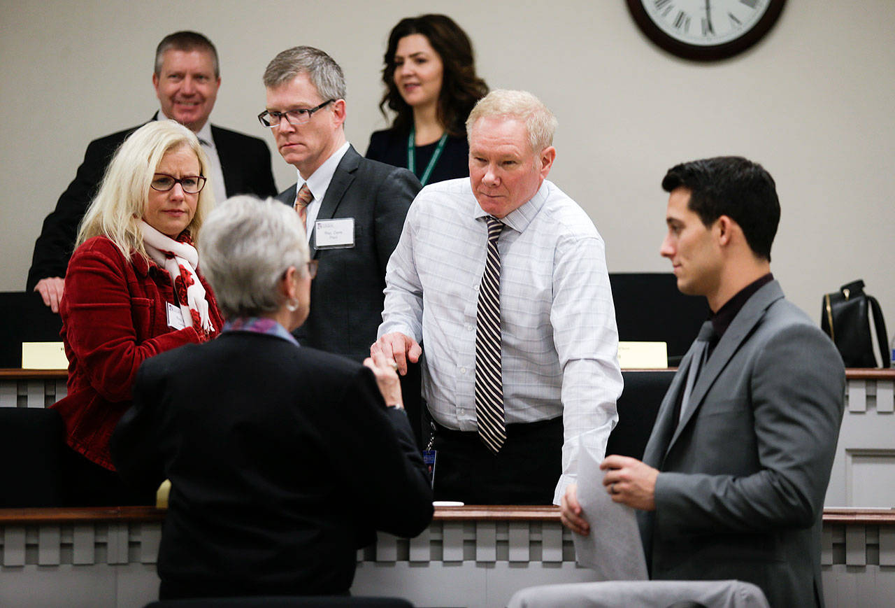 Rep. Carolyn Eslick, R-Sultan, (front) chats with incoming House freshmen from Snohomish County (from left), Democrat Dave Paul, of Oak Harbor, Republican Robert Sutherland, of Granite Falls, and Democrat Jared Mead, of Mill Creek, before an orientation session at the Capitol. The three men will be sworn into office Monday, at the start of the 2019 legislative session. (Andy Bronson / The Herald)