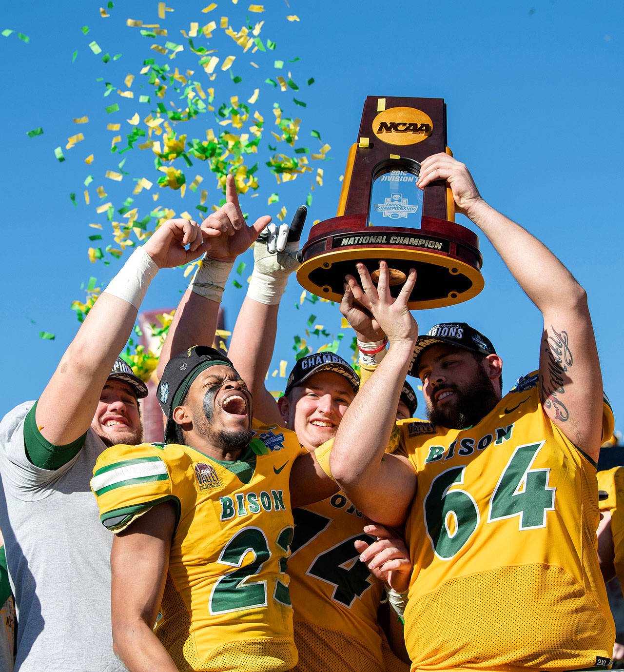 North Dakota State’s Jaylaan Wimbush (23), Colin Conner (64), and Tanner Volson (74) celebrate Saturday after the Bison after beat Eastern Washington 38-24 in the FCS Championship Game in Frisco, Texas. (AP Photo/Jeffrey McWhorter)