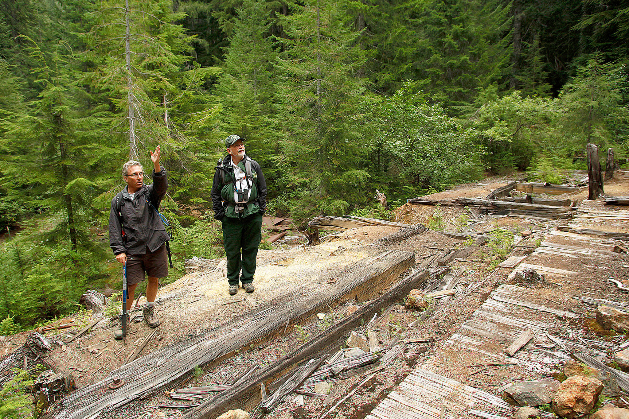 Forest Service mining reclamation expert Joe Gibbens, at left here in August 2012, speaks with U.S. Forest Service Ranger Peter Forbes. Forbes retired from the Forest Service Jan. 3, but his separation paperwork remains in limbo because of the partial shutdown of the federal government. (Mark Mulligan / Herald file)