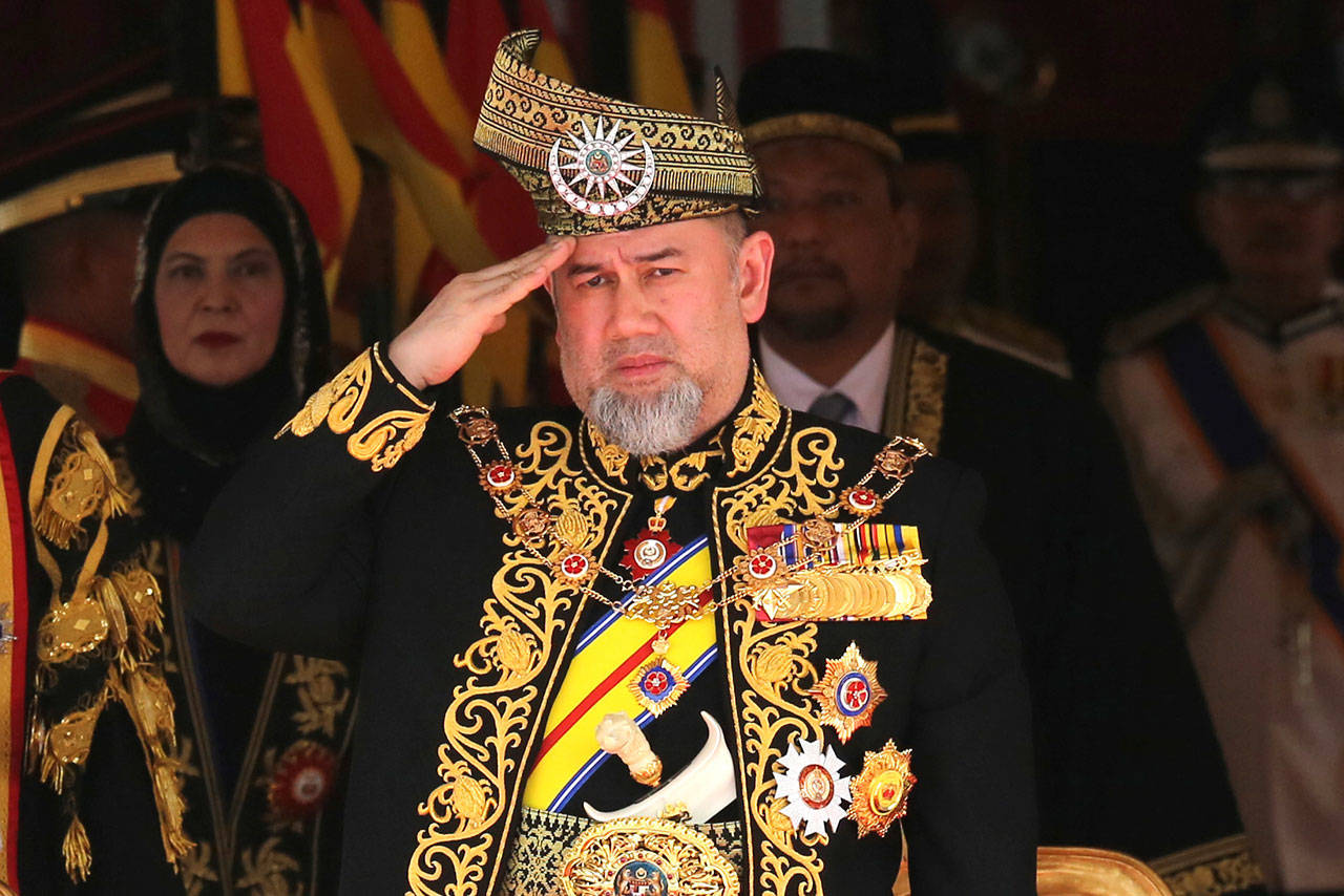 Malaysian King Sultan Muhammad V salutes during the national anthem at the opening of the 14th parliament session at the Parliament house in Kuala Lumpur, Malaysia, on July 17, 2018. Muhammad V has abdicated in an unexpected and rare move, just after two years on the throne. The palace said in a statement Sunday that Sultan Muhammad V, 49, has resigned with immediate effect, cutting short his five-year term, without giving any reasons. Sultan Muhammad V, ruler of northeast Kelantan state, was installed in December 2016 as one of the country’s youngest constitutional monarchs. (AP Photo/Yam G-Jun, File)