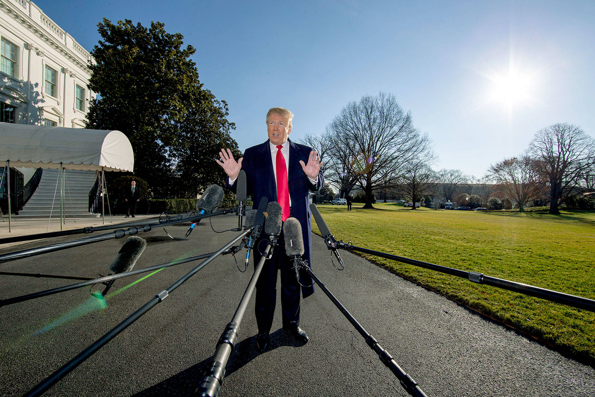 President Donald Trump speaks on the South Lawn of the White House as he walks to Marine One on Sunday en route to Camp David. (AP Photo/Alex Brandon)