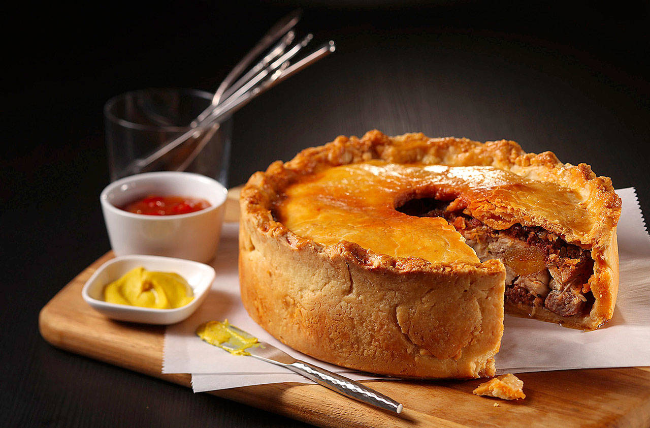 Pork goes into the crust (in the form of lard) and into the filling (with two kinds of sausage) in this meat pie. (Abel Uribe/Chicago Tribune)