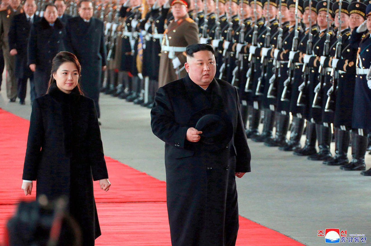 North Korean leader Kim Jong Un walks with his wife, Ri Sol Ju, at Pyongyang Station in Pyongyang, North Korea, on Monday before leaving for China.(Korean Central News Agency/Korea News Service via AP)