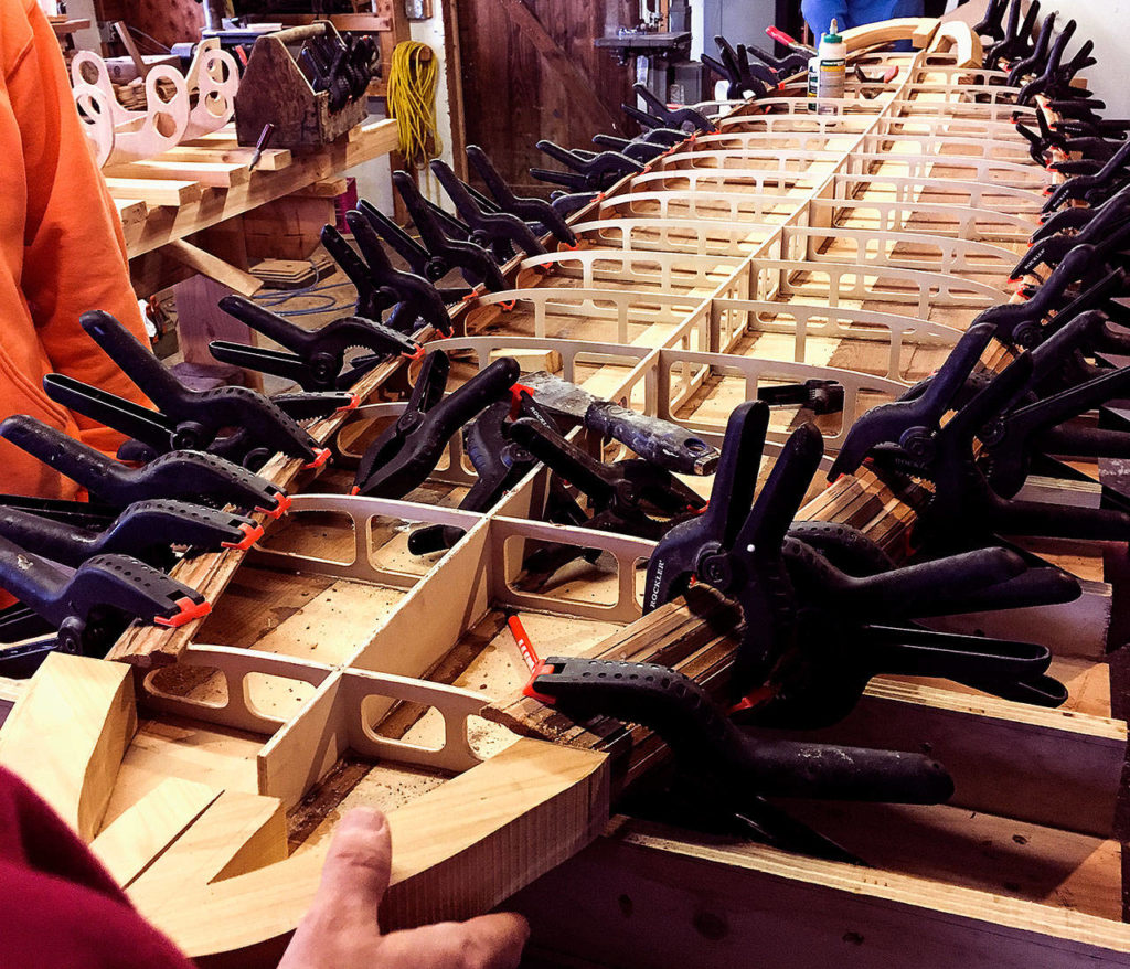 Heavy-duty clamps hold the rails tightly during the gluing process on the cedar-strip paddleboard. (Contributed Photo)
